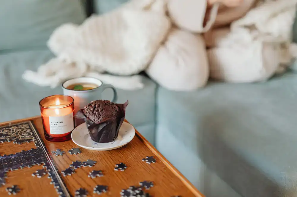 Friends working on a jigsaw puzzle with tea